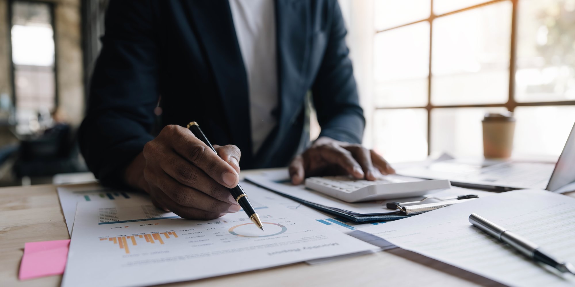 close-up-man-working-about-financial-with-calculator-his-office-calculate-expenses-accounting-concept